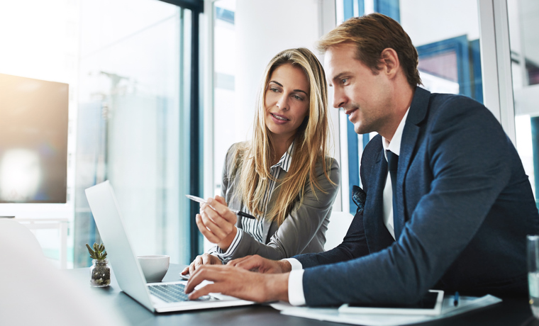 Cropped shot of two businesspeople working together on a laptop